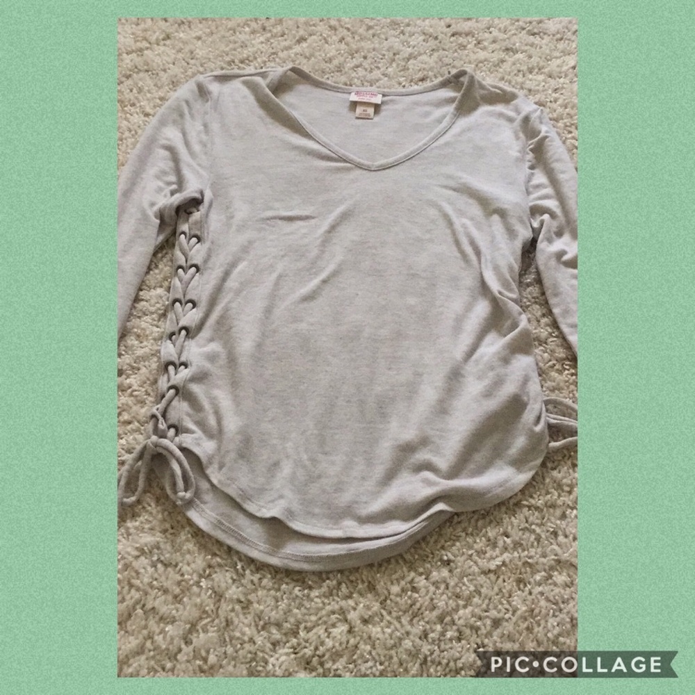 I am selling a grey long sleeved shirt.